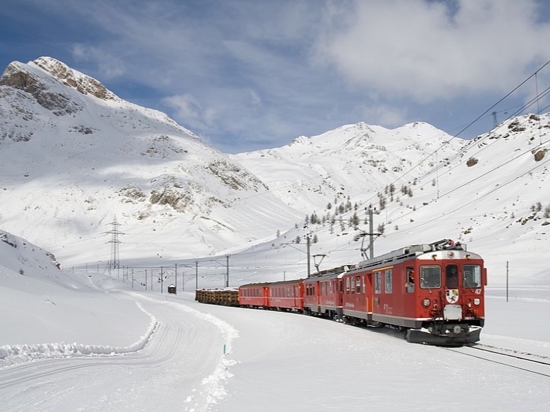 Red cogwheel train on a steep mountain track